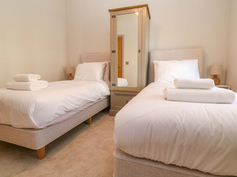A bedroom with twin beds and a wardrobe at 21 Alverton Street Penzance