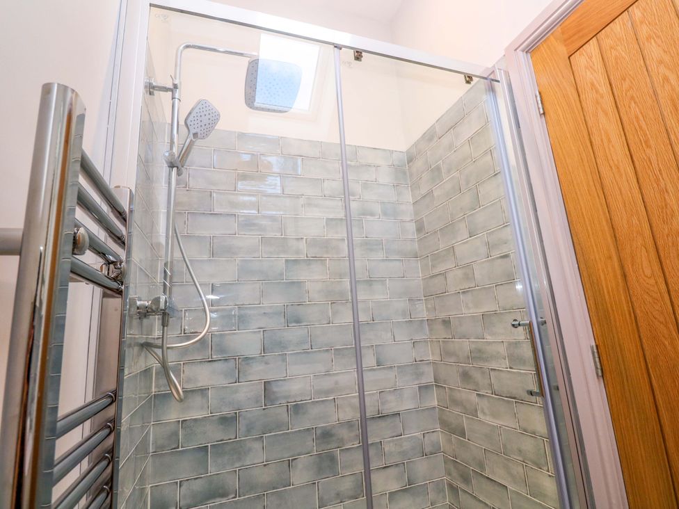 A shower with glass panel and tiled wall at 21 Alverton Street Penzance