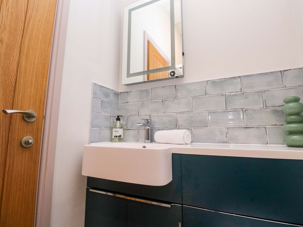 A bathroom with sink and mirror at 21 Alverton Street in Penzance