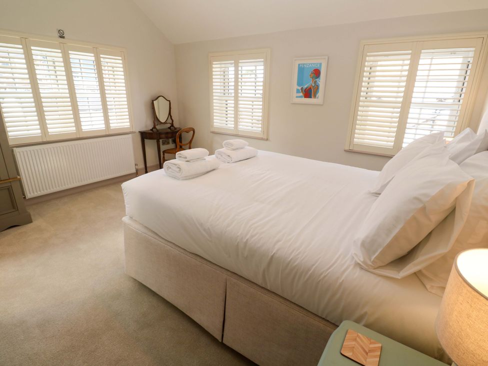 A bedroom with a bed and a mirror at 21 Alverton Street Penzance
