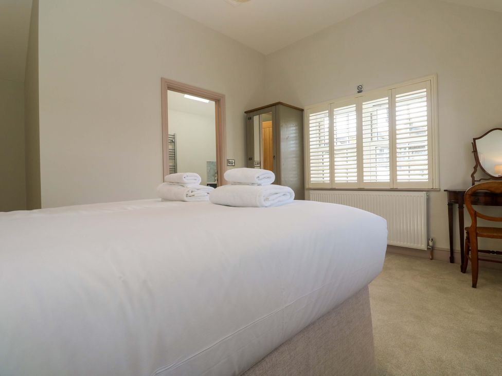 A bedroom with towels on the bed at 21 Alverton Street Penzance