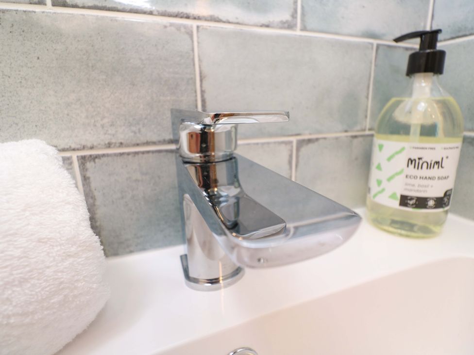 A faucet with hand soap and towel in a bathroom at 21 Alverton Street in Penzance