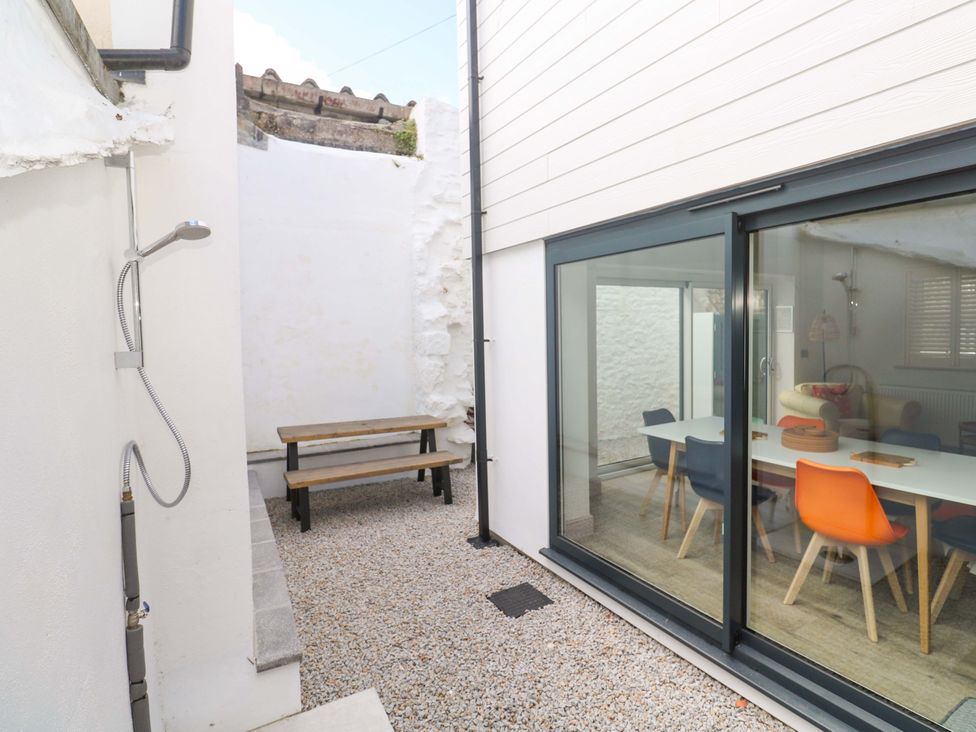 An outdoor area with a table, bench, and shower at 21 Alverton Street, Penzance