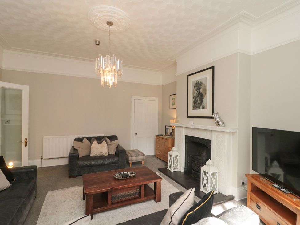 A living room with sofa and coffee table at Royal Victoria House in Scarborough