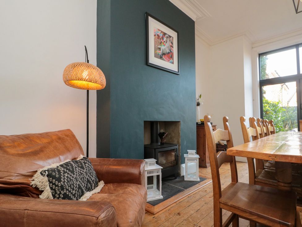 A dining room with a sofa and table at Royal Victoria House in Scarborough