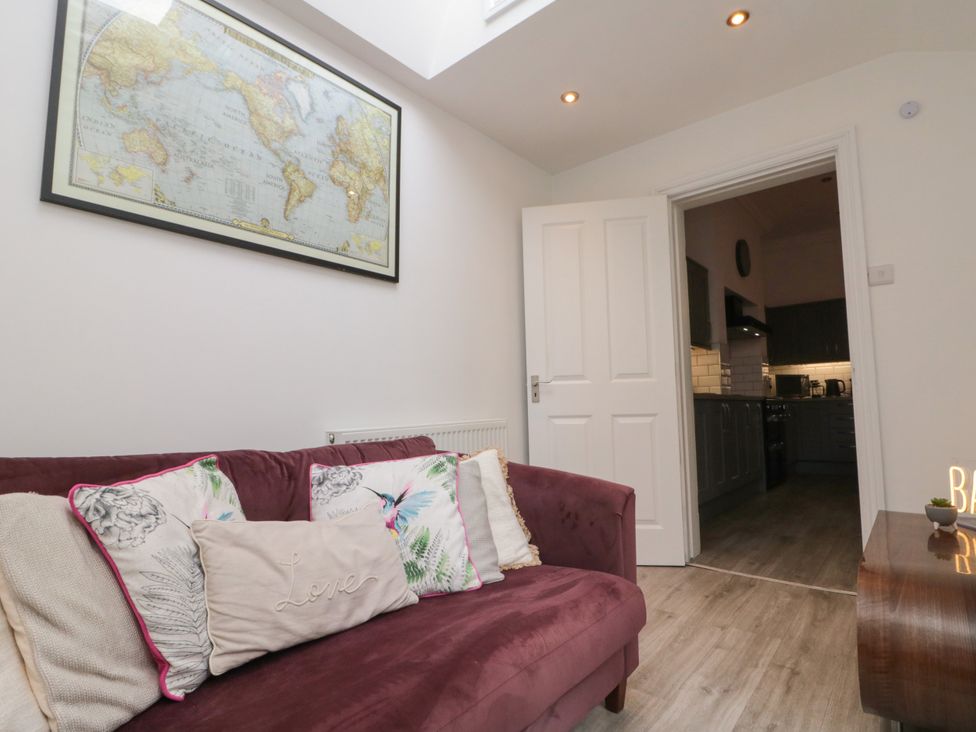 A living room with a sofa and map on the wall at Royal Victoria House Scarborough