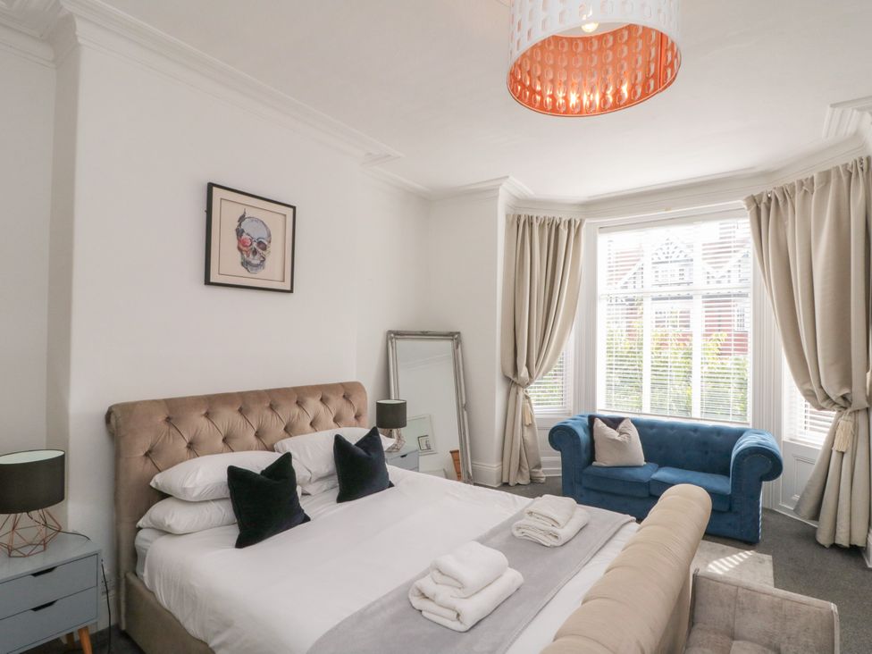 A bedroom with a bed and a sofa at Royal Victoria House in Scarborough