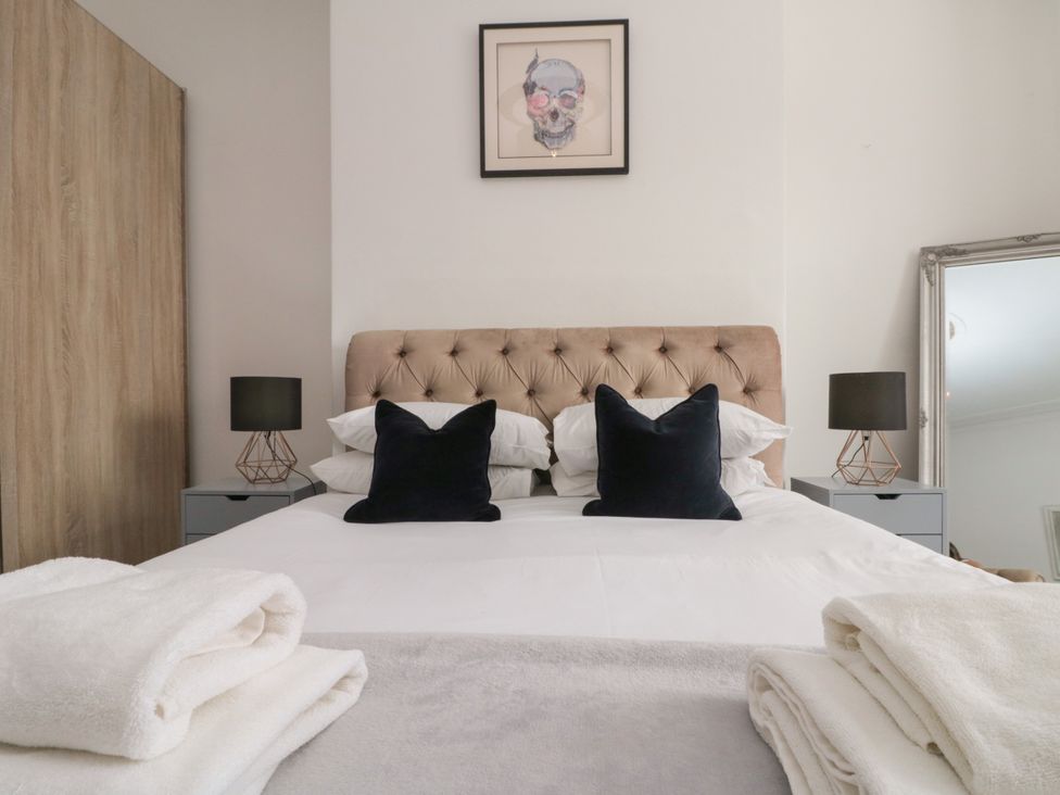 A bedroom with a bed and cushions at Royal Victoria House in Scarborough