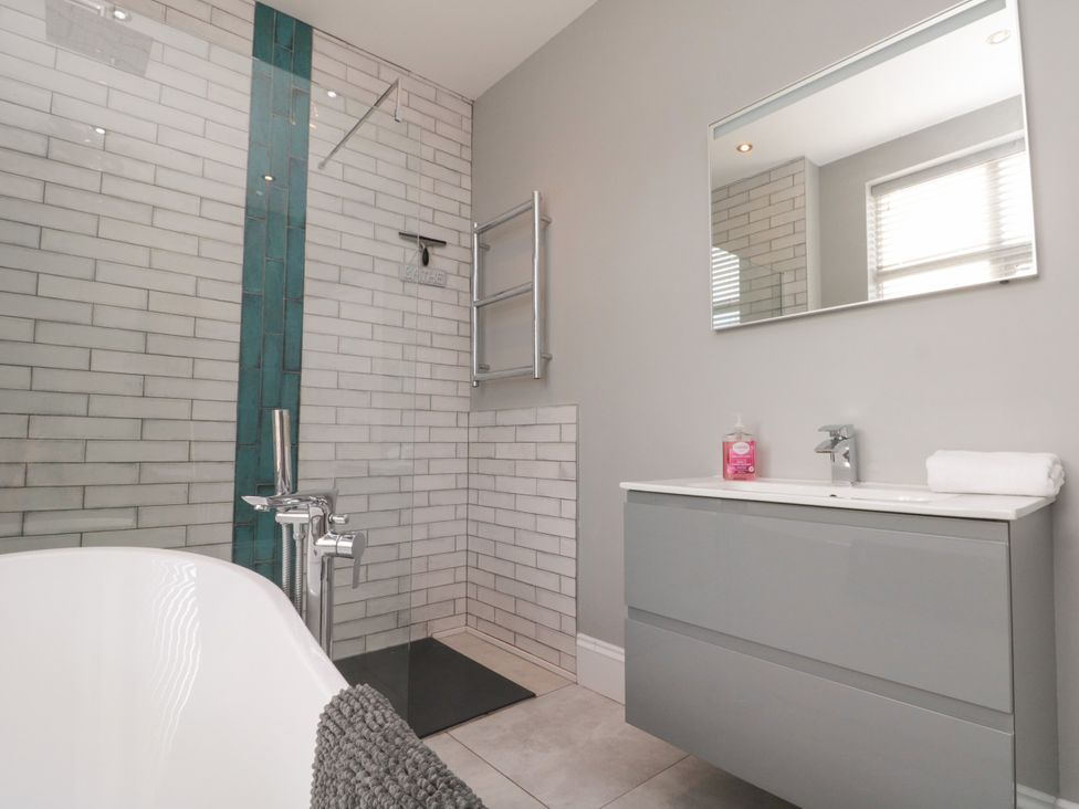 A bathroom with a tub and shower at Royal Victoria House in Scarborough
