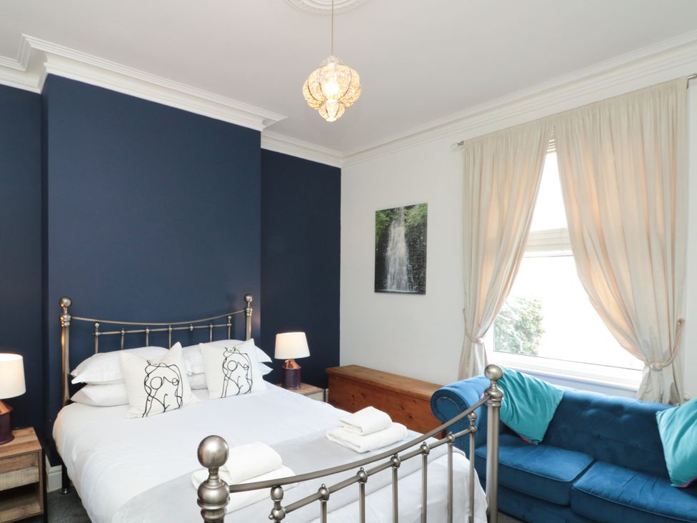 A bedroom with a bed and a sofa at Royal Victoria House Scarborough