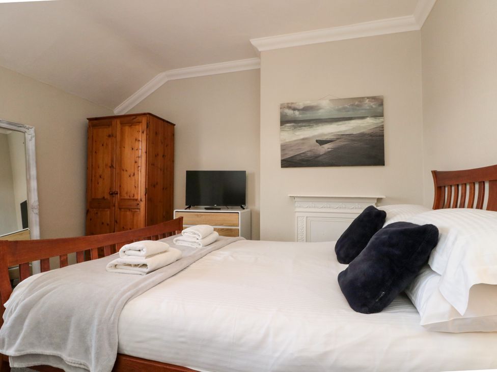 A bedroom with a bed and television at Royal Victoria House in Scarborough