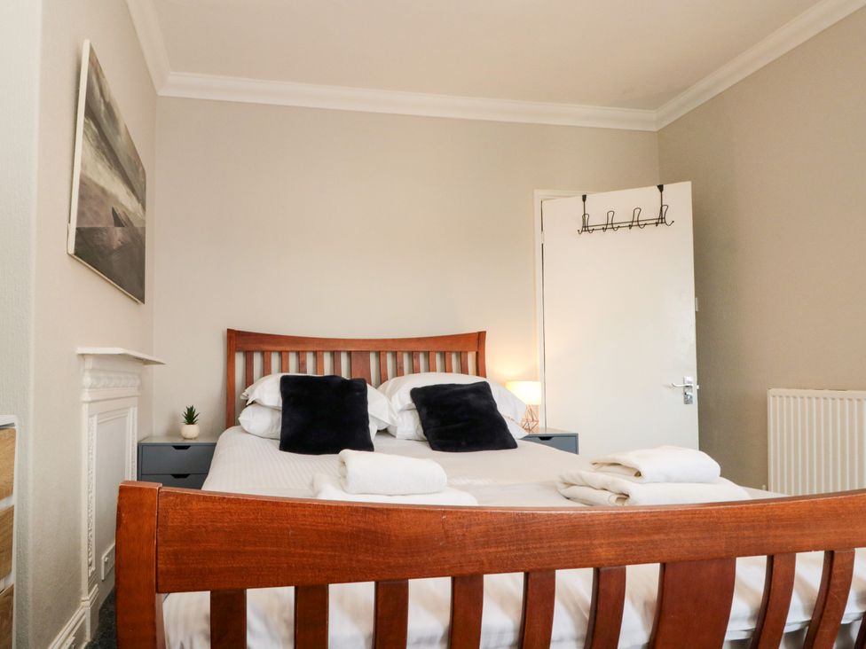 A bedroom with a bed and nightstand at Royal Victoria House Scarborough