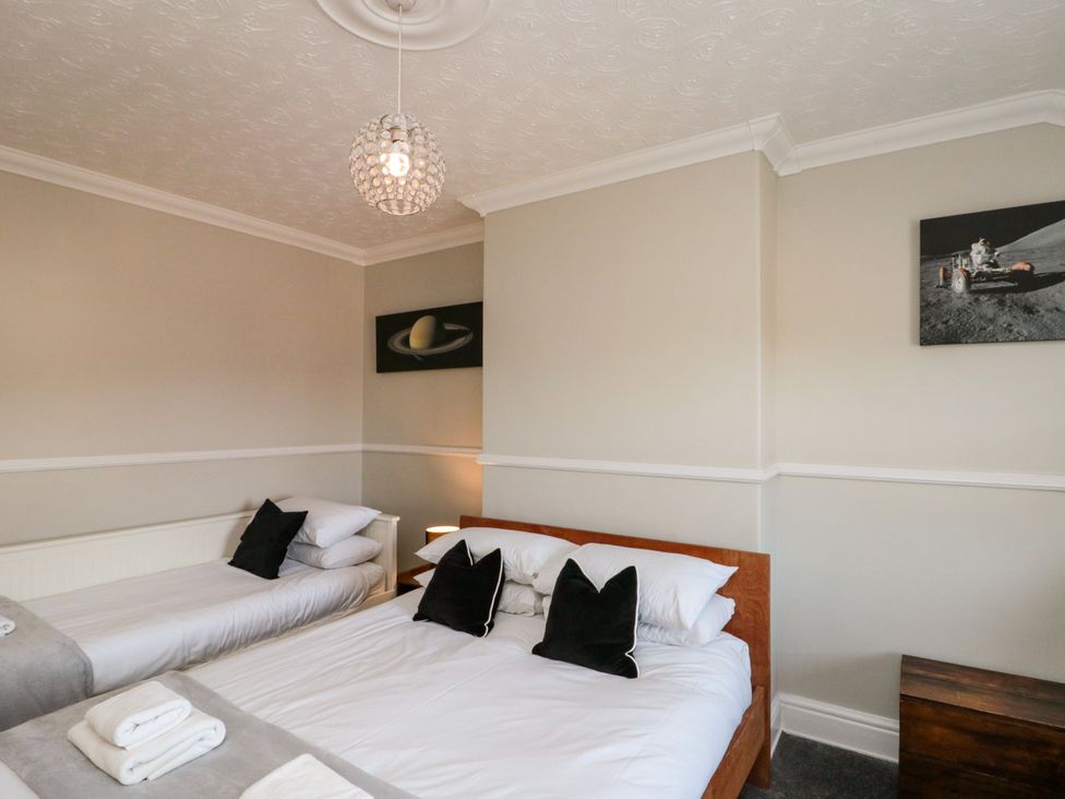 A bedroom with two beds and decorative art at Royal Victoria House in Scarborough
