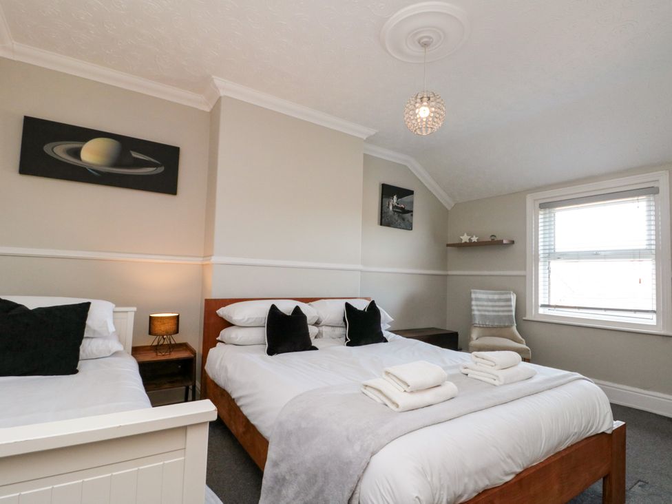 A bedroom with two beds and a window at Royal Victoria House, Scarborough