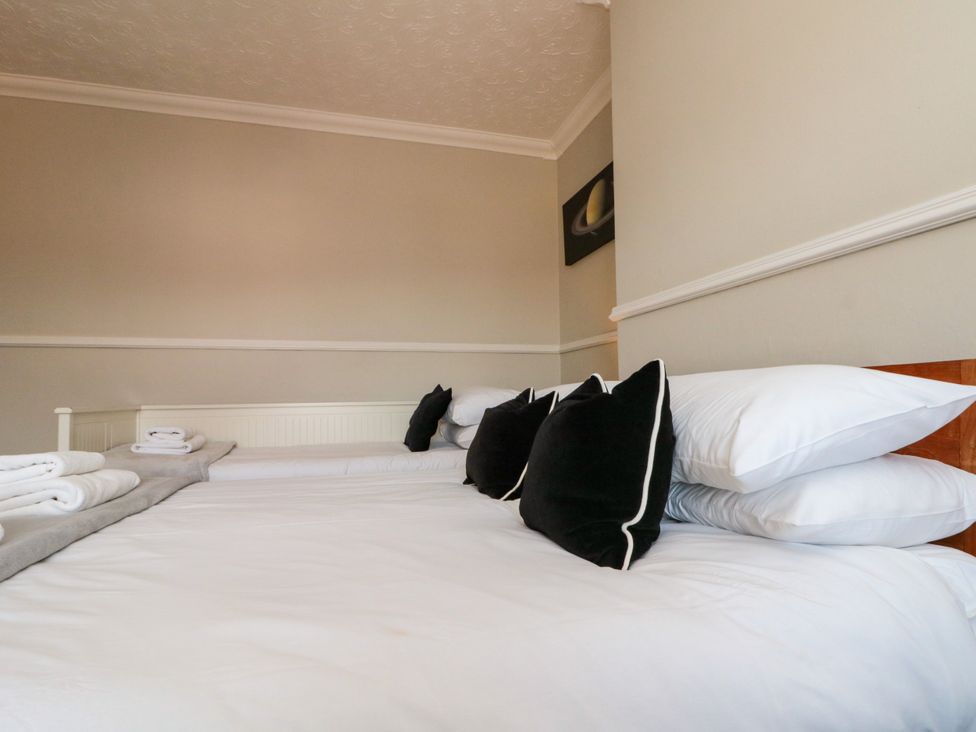 A bedroom with a bed and pillows at Royal Victoria House in Scarborough