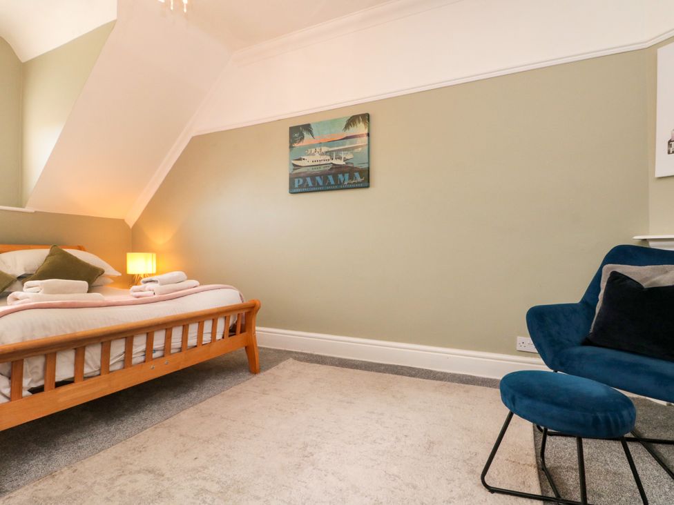 A bedroom with a bed and a chair at Royal Victoria House in Scarborough