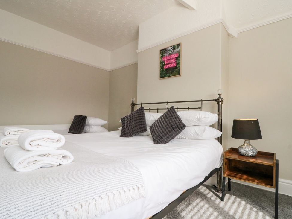 A bedroom with a bed and bedside table at Royal Victoria House Scarborough