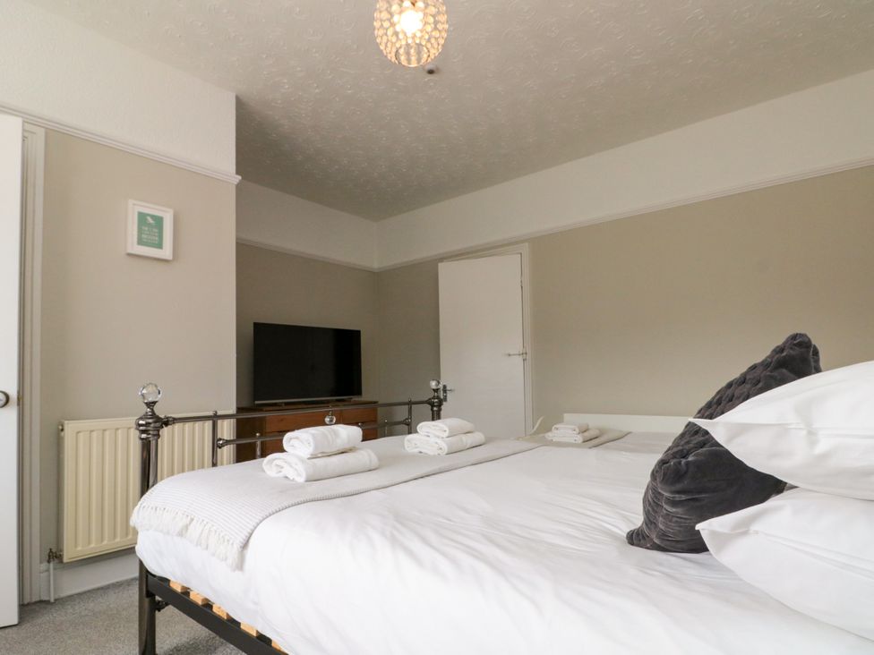 A bedroom with a bed and television at Royal Victoria House in Scarborough