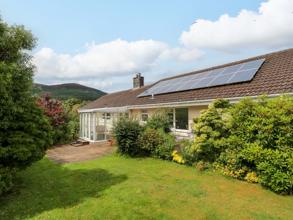 A house with a garden and solar panels at Knockendoch in New Abbey
