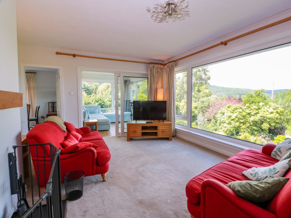 A living room with a sofa and television at Knockendoch in New Abbey