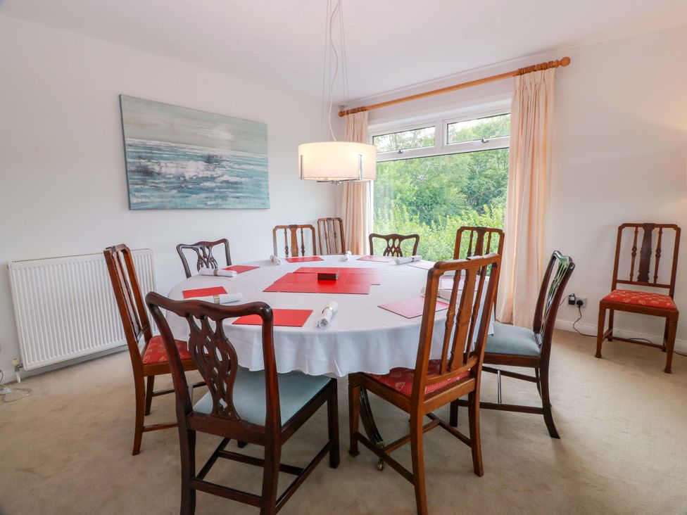 A dining room with a table and chairs at Knockendoch New Abbey