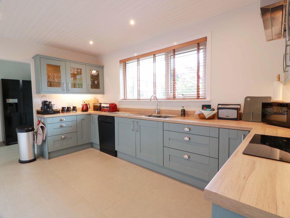A kitchen with appliances and cabinetry at Knockendoch New Abbey