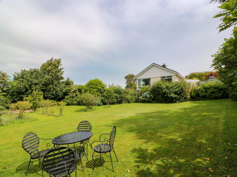 A garden with a table and chairs at Knockendoch in New Abbey