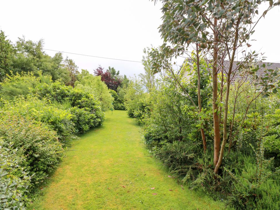 A garden path surrounded by trees and bushes at Knockendoch in New Abbey