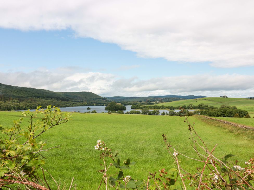 A landscape view of a lake and hills at Knockendoch in New Abbey