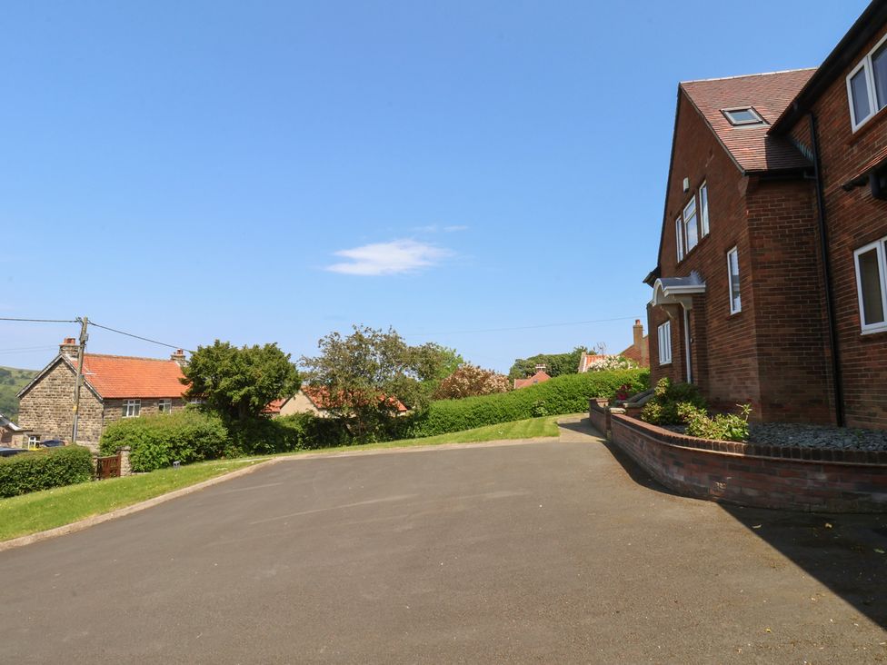A driveway with houses and greenery at 21 Eskdaleside Sleights