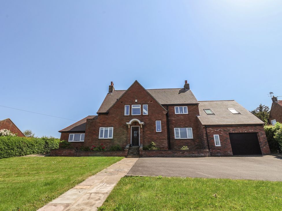 A house with a driveway and garden at 21 Eskdaleside Sleights