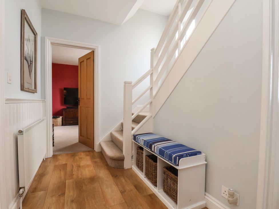 A hallway with stairs and a bench at 21 Eskdaleside in Sleights
