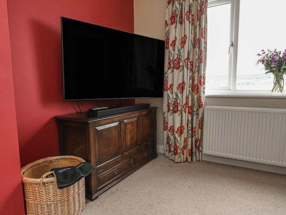 A living room with a television and cabinet at 21 Eskdaleside Sleights
