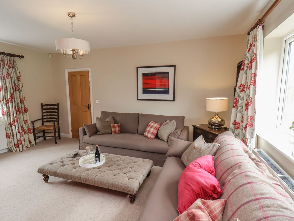 A living room with a sofa and coffee table at 21 Eskdaleside Sleights