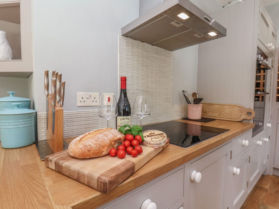 A kitchen with a cutting board and food items at 21 Eskdaleside Sleights