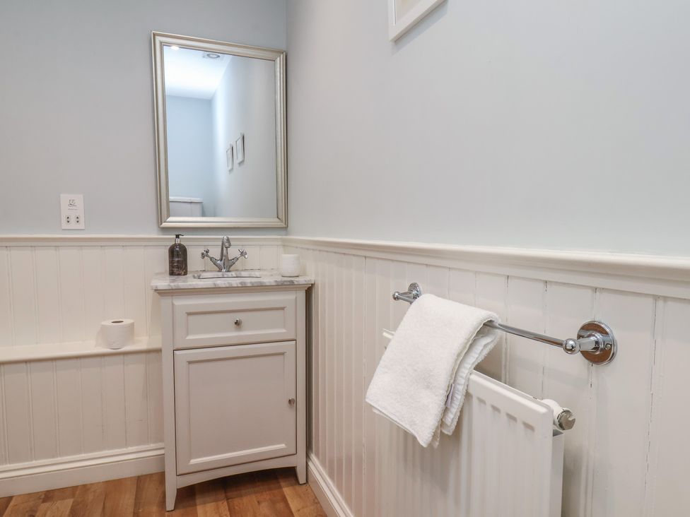 A bathroom with a sink and mirror at 21 Eskdaleside Sleights