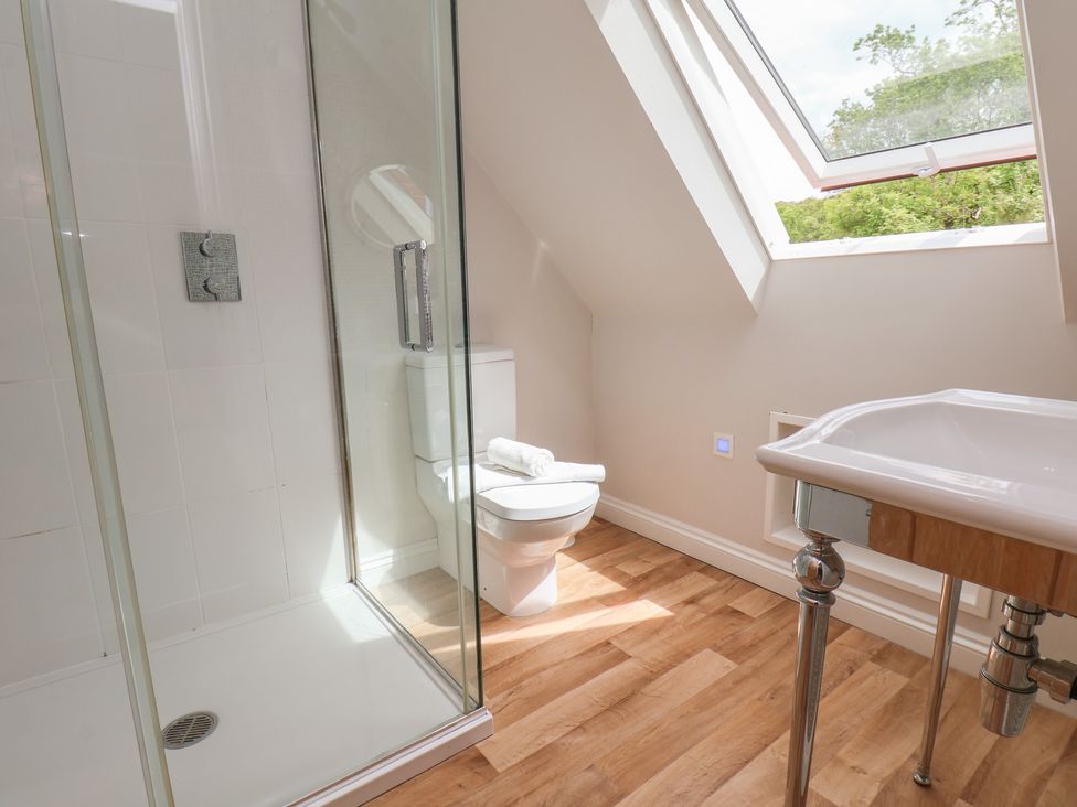 A bathroom with shower, toilet, and sink at 21 Eskdaleside Sleights