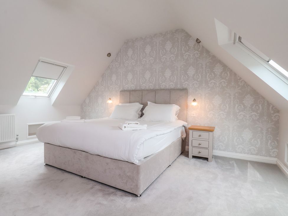 A bedroom with a bed and bedside table at 21 Eskdaleside, Sleights