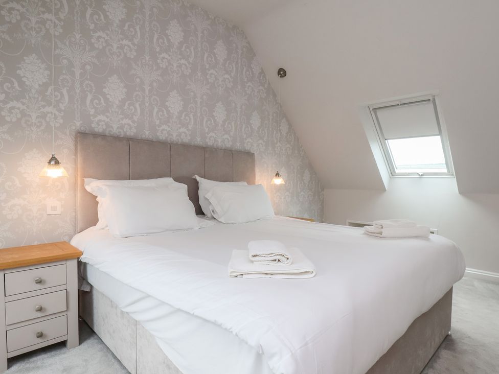 A bedroom with a bed and bedside table at 21 Eskdaleside in Sleights