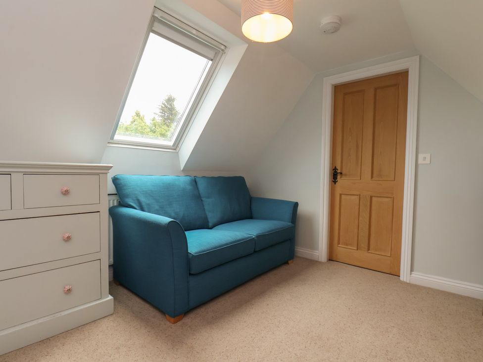 A room with a sofa, drawer and window at 21 Eskdaleside Sleights