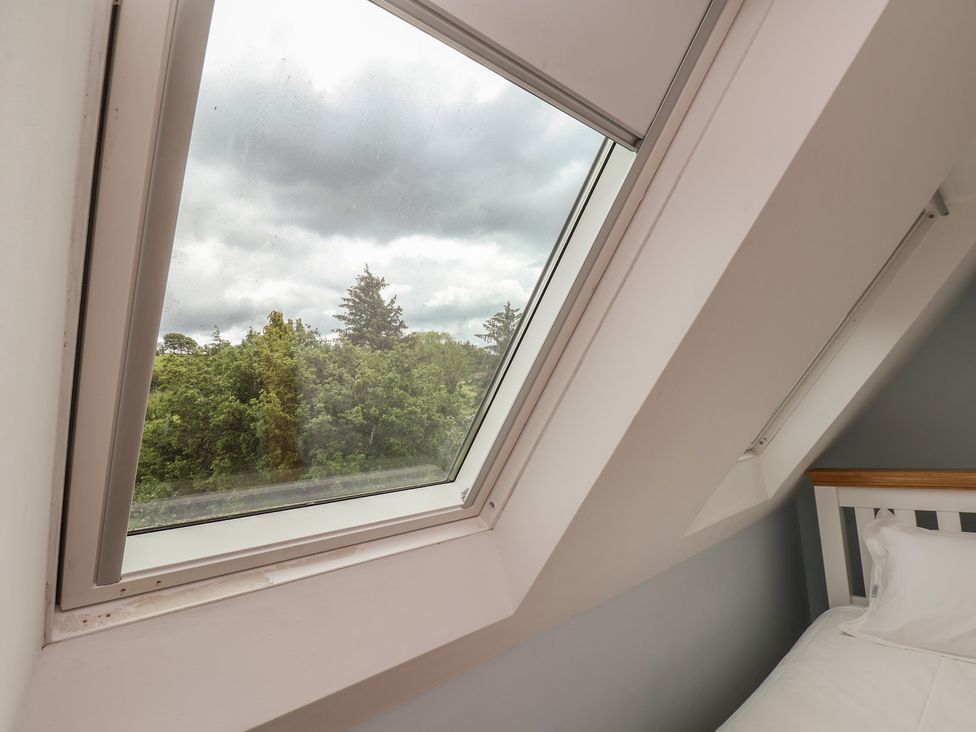 A bedroom window showing trees and clouds at 21 Eskdaleside Sleights