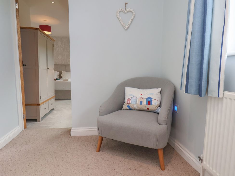 A bedroom with an armchair and wardrobe at 21 Eskdaleside Sleights