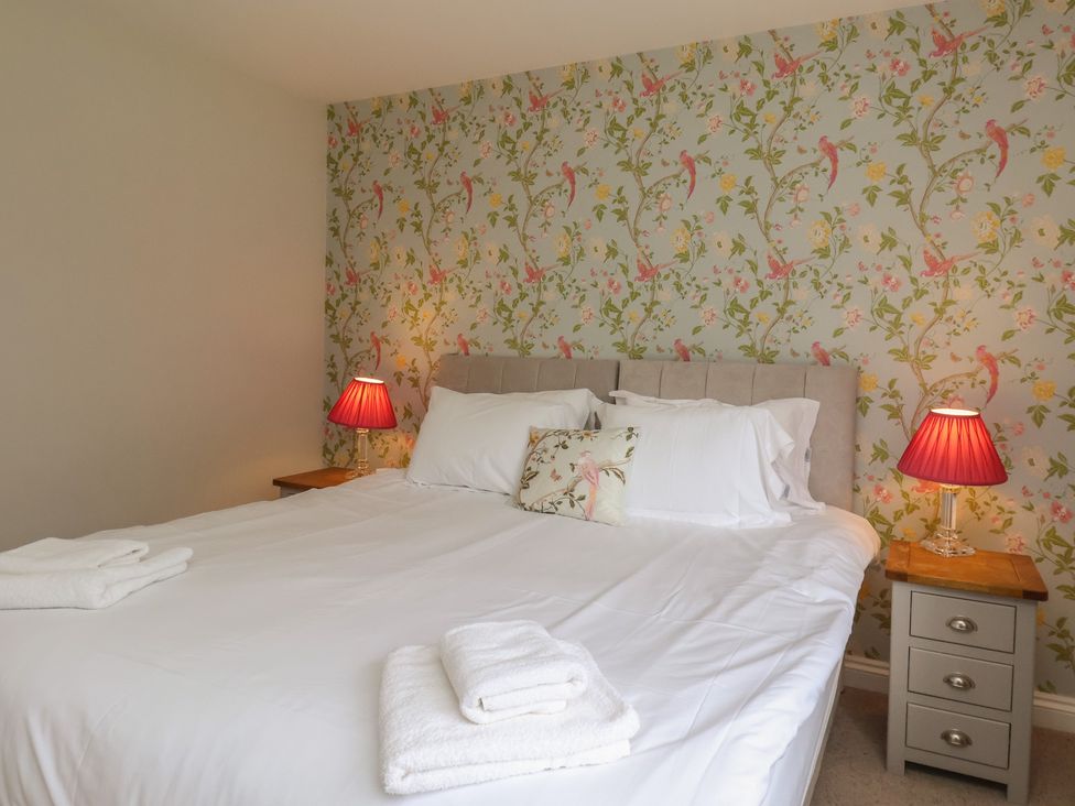 A bedroom with a bed and nightstand at 21 Eskdaleside Sleights
