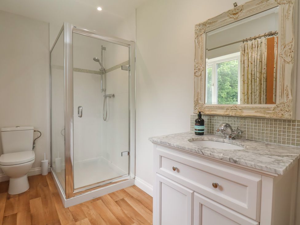 A bathroom with a shower, toilet, and sink at 21 Eskdaleside in Sleights