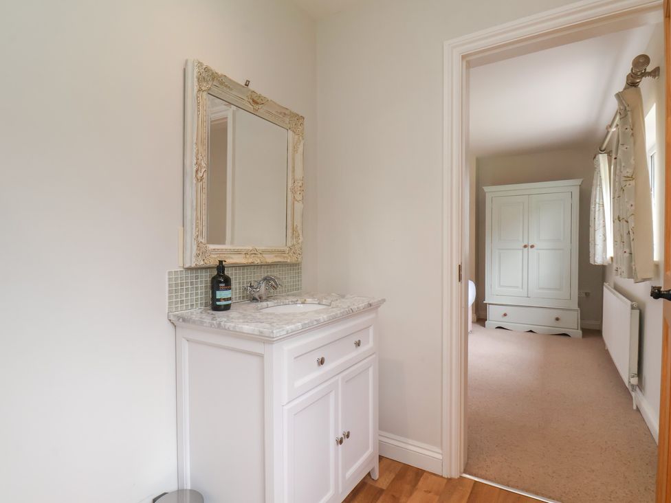 A bathroom with a vanity and mirror at 21 Eskdaleside Sleights