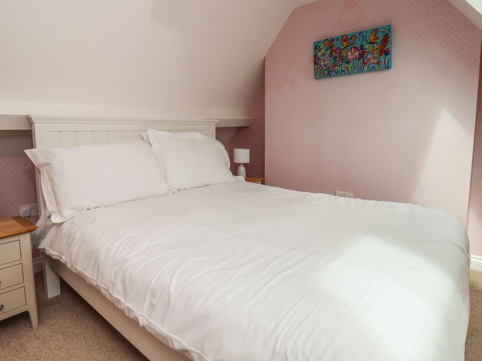 A bedroom with a bed and nightstand at 21 Eskdaleside Sleights