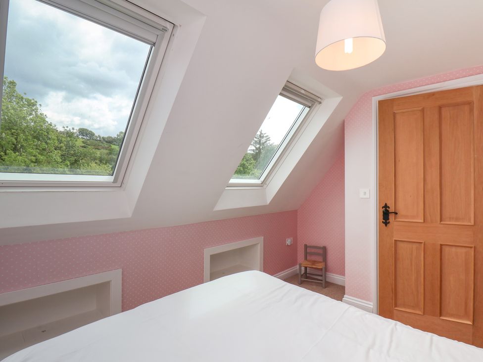 A bedroom with windows and a door at 21 Eskdaleside Sleights
