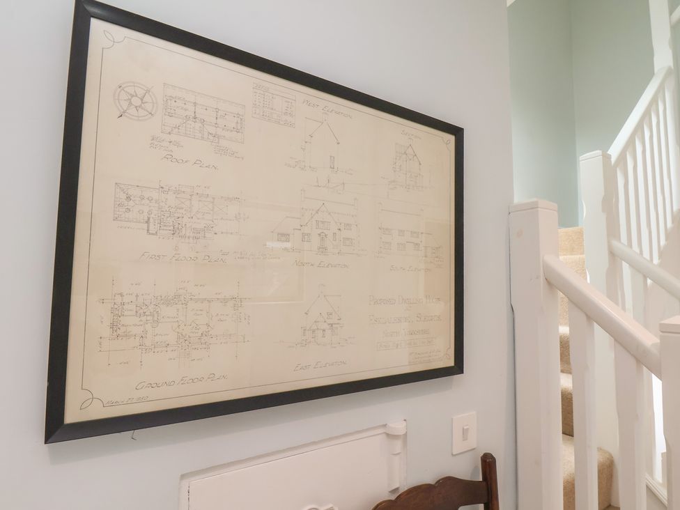 A blueprint displayed on the wall near a staircase at 21 Eskdaleside Sleights