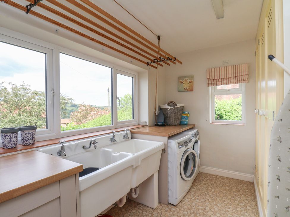 A laundry room with a wash basin and washing machine at 21 Eskdaleside Sleights