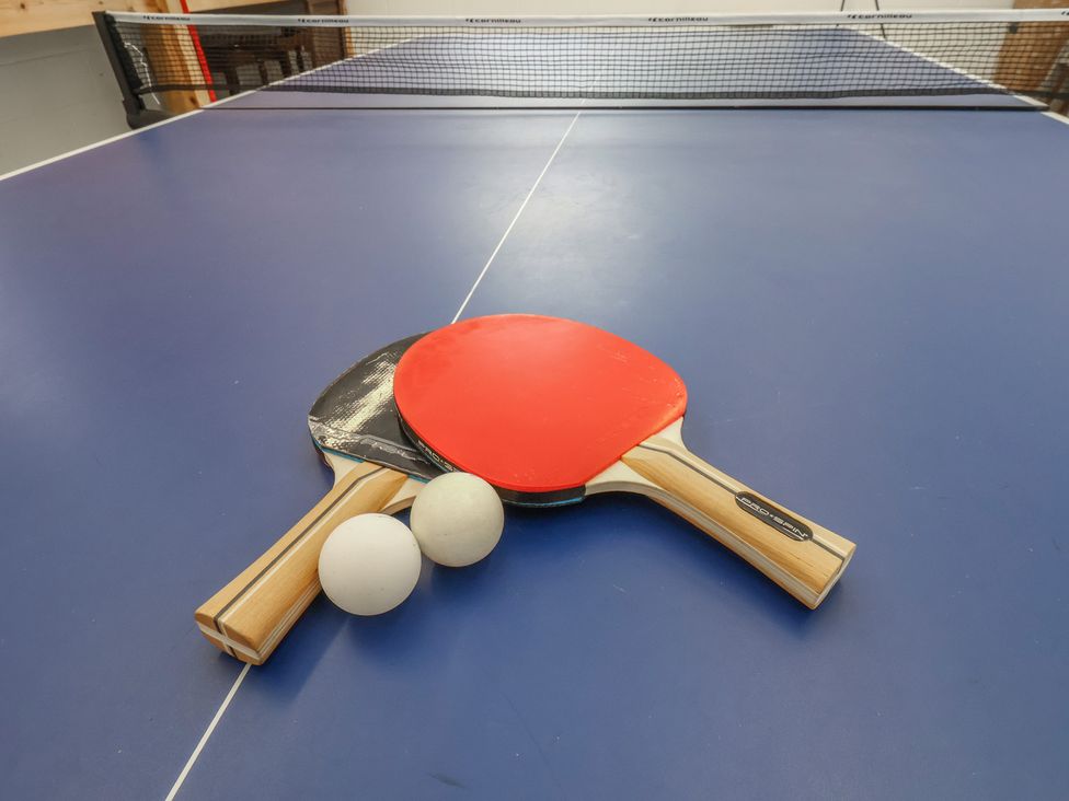A table tennis setup with paddles and balls at a sports facility
